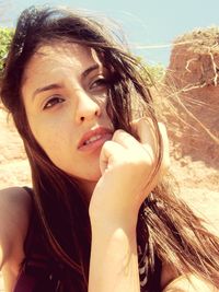 Close-up of young woman looking away on sunny day