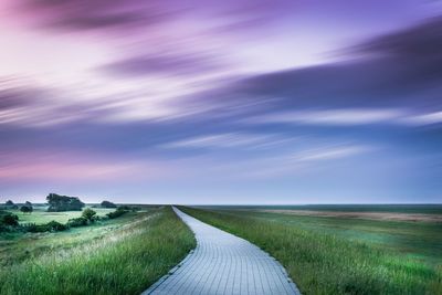 Scenic view of agricultural field against dramatic sky