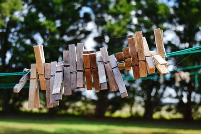 Close-up of clothespins hanging on clothesline