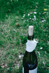 High angle view of beer bottle on field