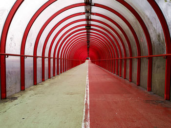 Empty red covered footbridge