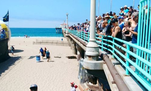 People at beach against sky