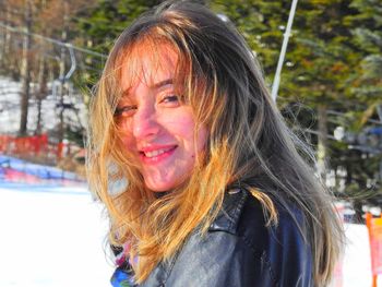 Portrait of smiling woman in snow