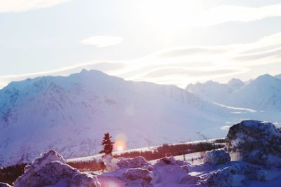 Scenic view of snow covered mountains against sky