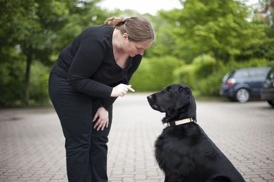 Full length of woman with dog