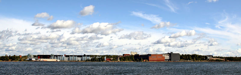 Panoramic view of buildings and sea against sky