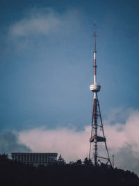 Low angle view of communications tower and buildings against sky, tbilisi georgia country