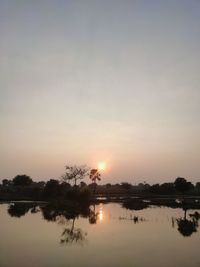 Scenic view of lake against sky during sunset