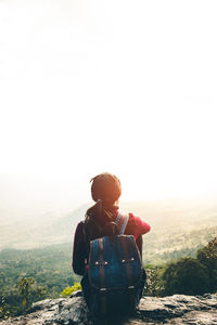 Man standing on mountain against clear sky