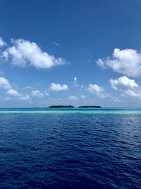Scenic view of sea against blue sky