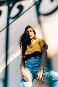 Portrait of young woman sitting outdoors
