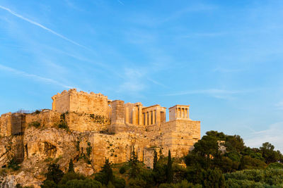 Low angle view of old ruins against blue sky