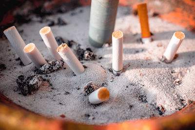 Close-up of cigarette butts in ashtray