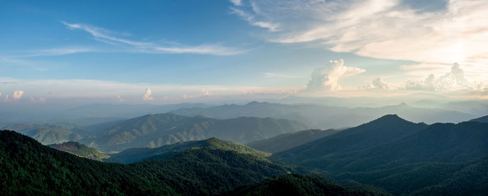 Panorama of mountain views, smooth greenery. natural atmosphere evening light bright clouds and sky.