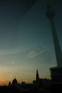 Low angle view of built structure against sky at sunset