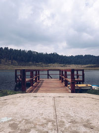 Pier over lake against sky