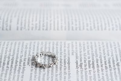 High angle view of ring on open book