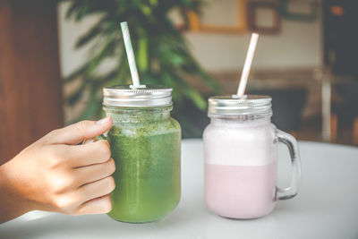 Cropped hand of woman holding drink