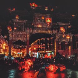 Illuminated city against sky at night