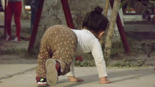 Rear view of girl standing outdoors