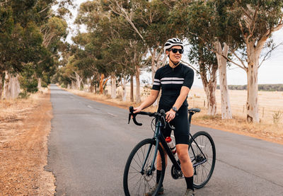 Man riding bicycle on road