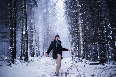 Full length of woman standing on snow covered land