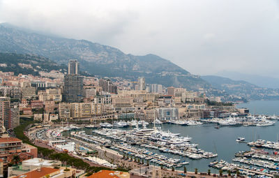 High angle view of bay and buildings against sky