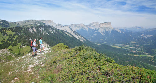 People on mountain against sky