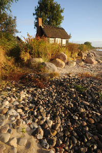 Stones by stone wall against sky