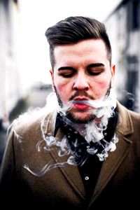 Close-up of man exhaling smoke