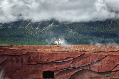 Scenic view of land against cloudy sky