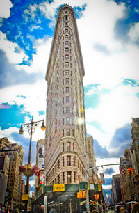 Low angle view of buildings against cloudy sky