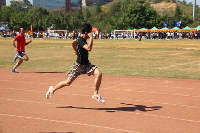 Group of people running at park