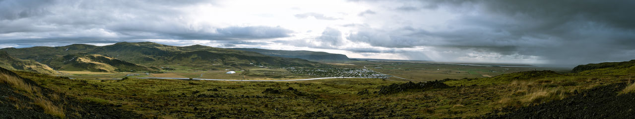 Scenic view of mountains against cloudy sky