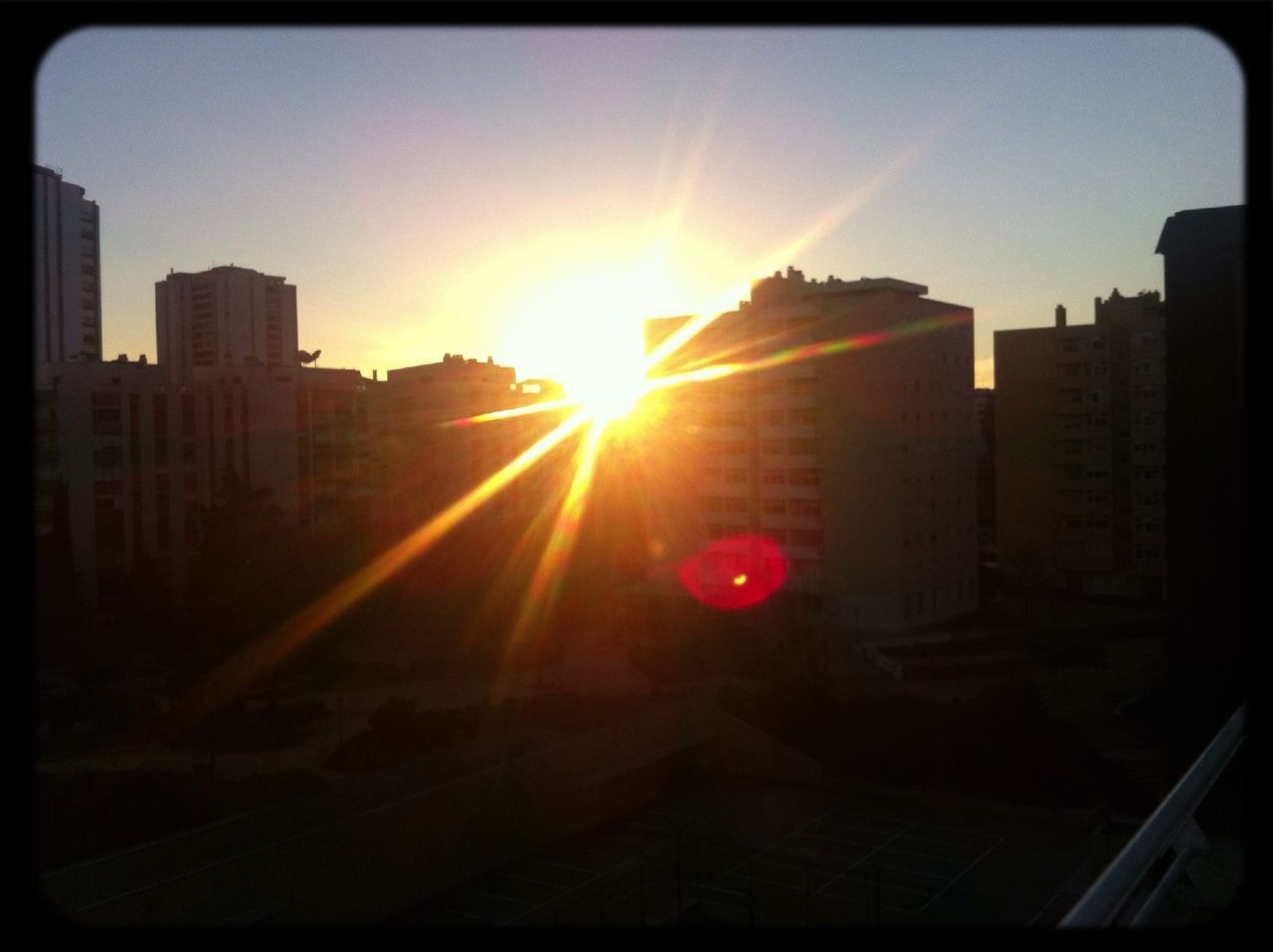 building exterior, sun, architecture, built structure, sunset, city, sunbeam, sunlight, lens flare, transfer print, auto post production filter, silhouette, sky, building, orange color, residential building, residential structure, skyscraper, outdoors, bright