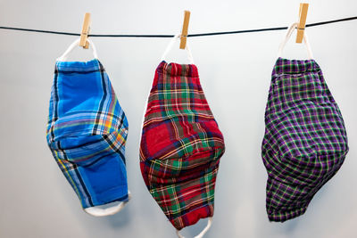 Close-up of multi colored clothespins hanging on rack