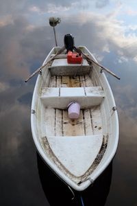 Close-up of boat moored on sea against sky