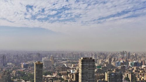 High angle view of buildings in city against sky