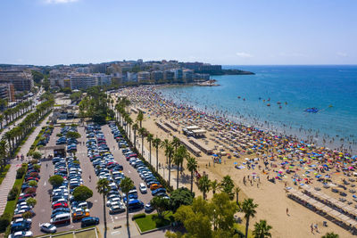 High angle view of city by sea against sky