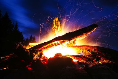 Low angle view of firework display at night