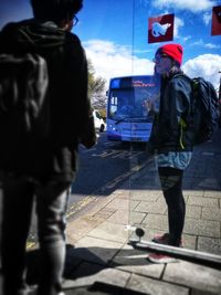 Rear view of man standing on railroad station