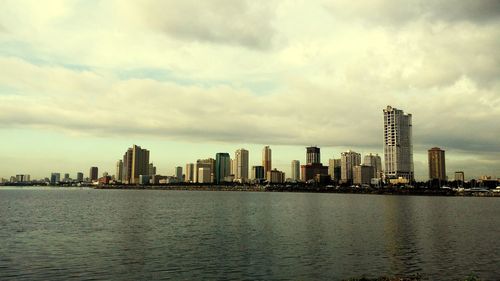 City skyline against cloudy sky