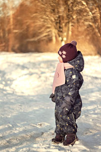 Rear view of woman standing on land