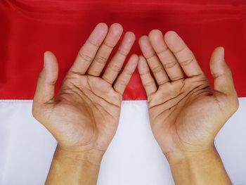 Close-up of human hand against red background