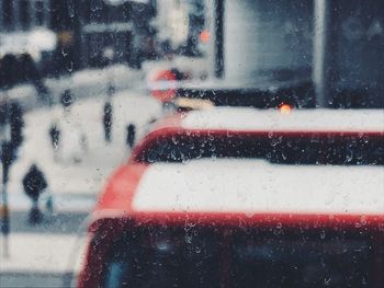 Close-up of raindrops on glass window during rainy season