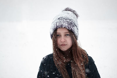 Portrait of beautiful young woman in snow