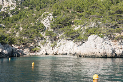 Scenic view of sea by mountain