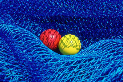 Close-up of balls on net