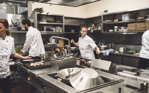 Chefs working in commercial kitchen at restaurant