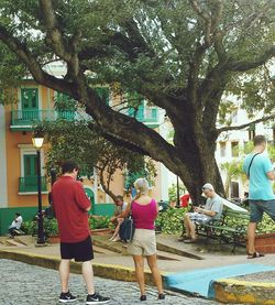 Woman standing on tree trunk